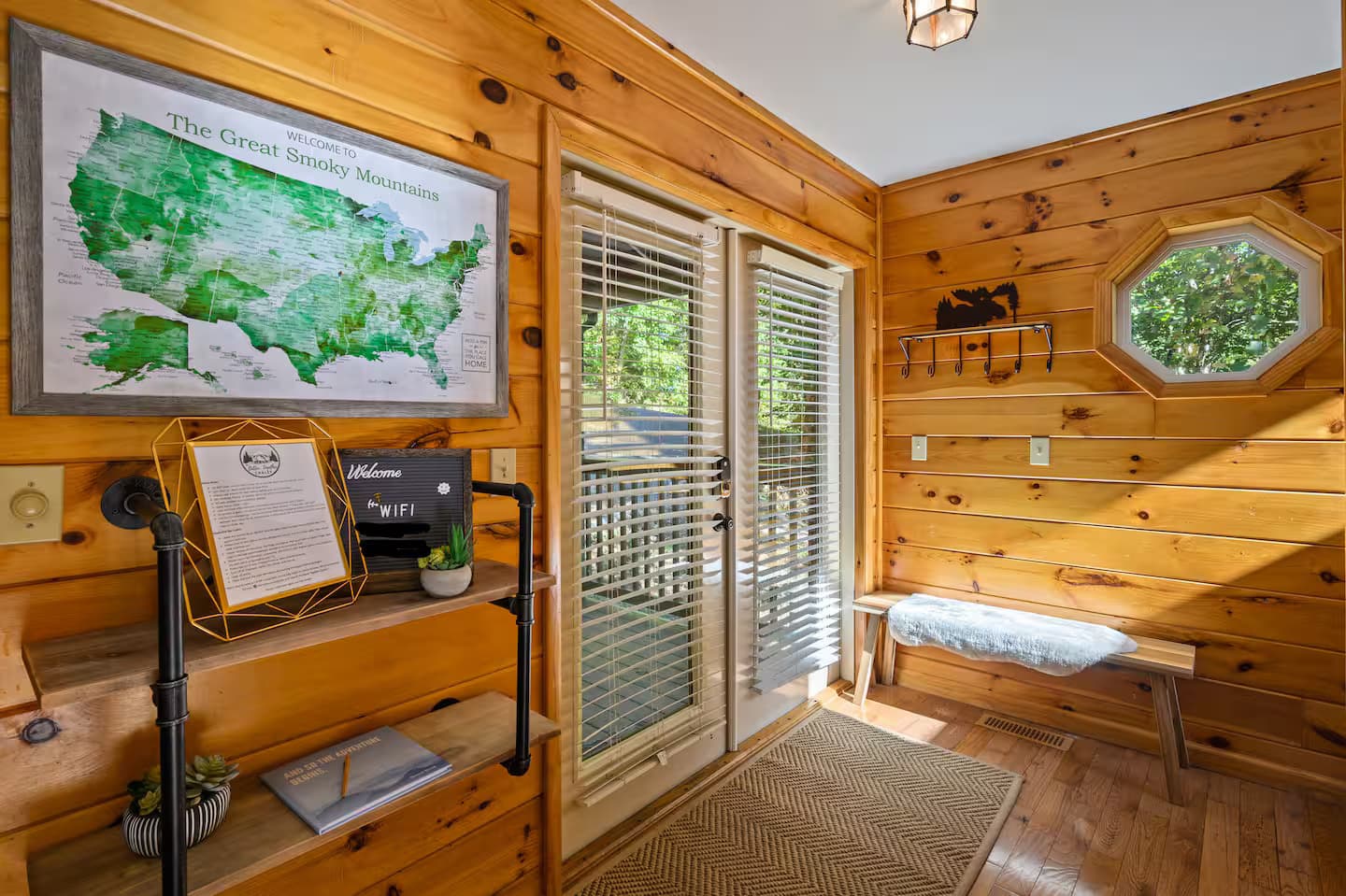 An entryway with a Great Smoky Mountains map, coat hooks, and a bench.