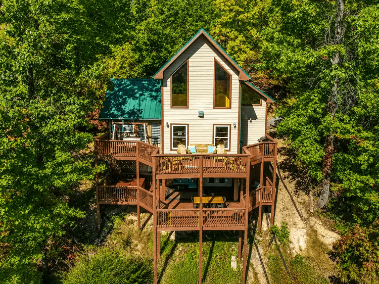 Front aerial view of Smoky Mountain Lookout and its tiered wooden decks surrounded by forest.